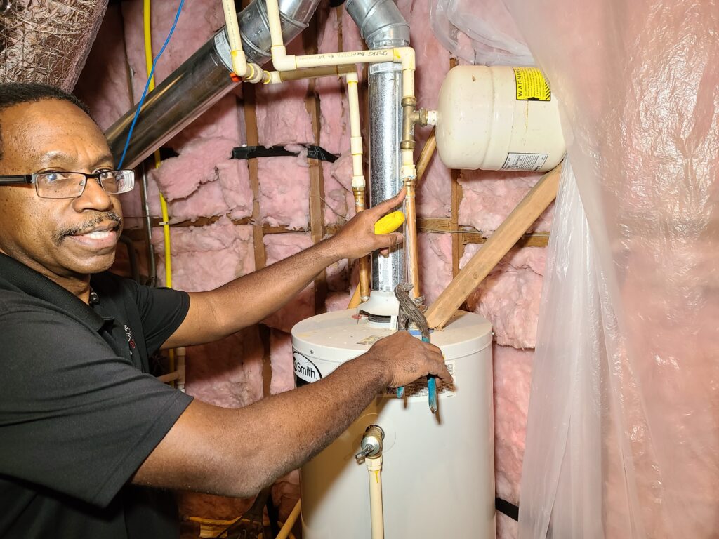 20210411_154009 Dale Johnson of the Civilized Plumber working on a water heater